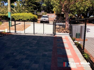 Black Chainmesh Fence installation view from inside the gate. Supplied and installed in a residential home in Mt. Hawthorn WA.