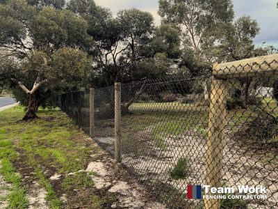 Black chain link fence with pine poles supply and installation by Team Work Fencing Contractors
