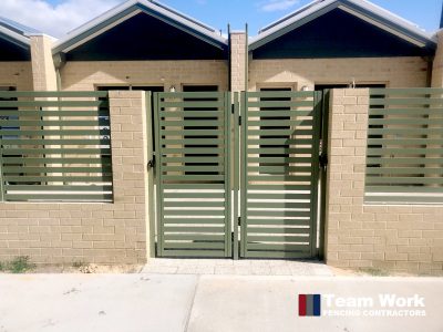 Green Aluminium slat fence with vertical slats and gate installed in Perth WA